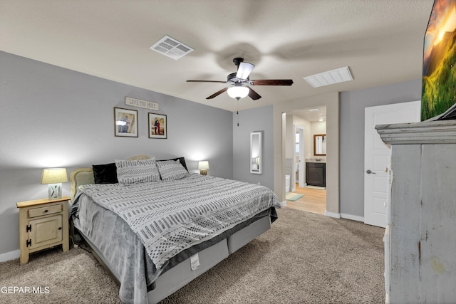 14953 Willie Worsley Ave, El Paso, TX 79938 - bedroom featuring light colored carpet, baseboards, connected bathroom, and ceiling fan