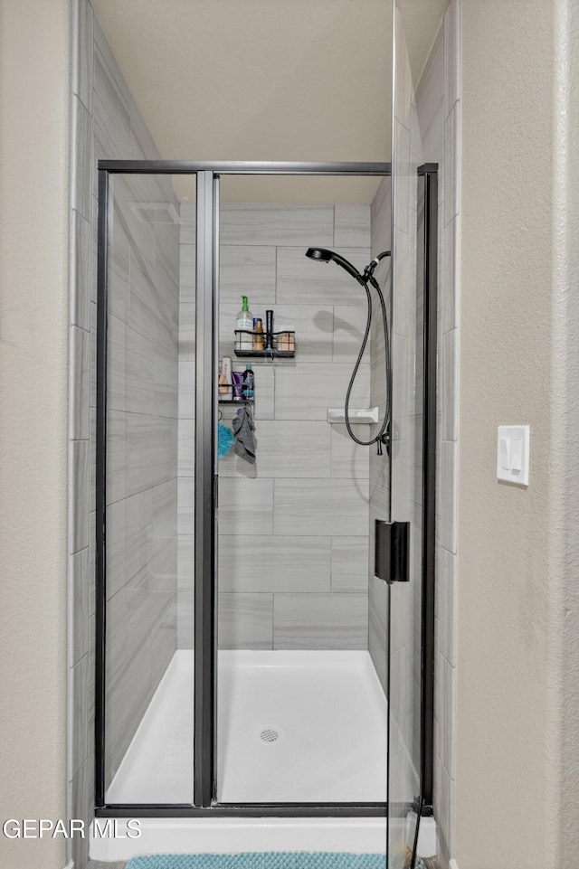 14953 Willie Worsley Ave, El Paso, TX 79938 - full bathroom with a shower stall and a textured wall