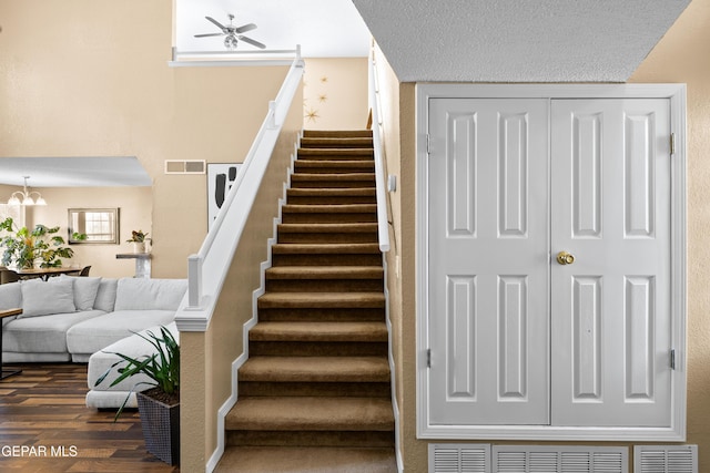 7107 Desert Jewel Dr, El Paso, TX 79912 - staircase with wood finished floors, ceiling fan, and a chandelier