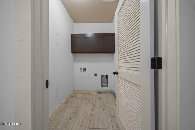14677 Christian Castle, El Paso, TX 79938 - laundry room featuring cabinet space, electric dryer hookup, washer hookup, light wood-style floors, and baseboards