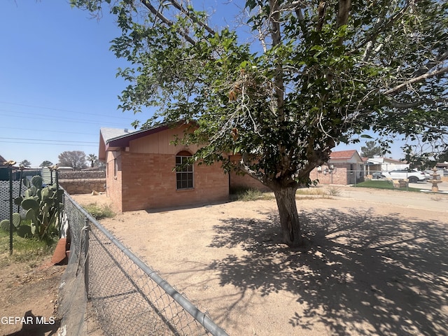 9348 Elgin Dr, El Paso, TX 79907 - view of property exterior with brick siding and fence