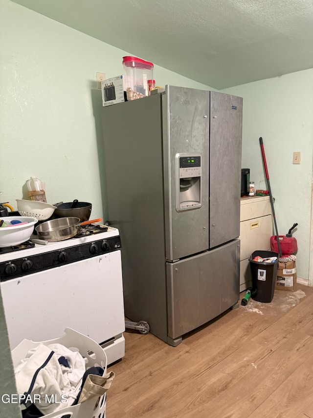 56 Palm St, El Paso, TX 79901 - kitchen featuring stainless steel refrigerator with ice dispenser and light wood finished floors