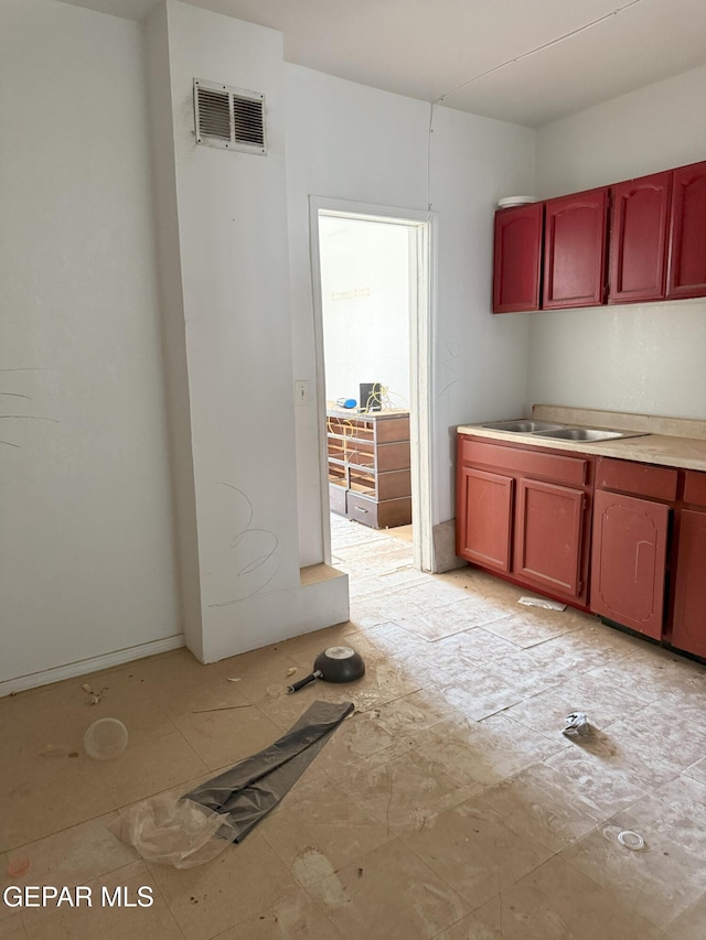 56 Palm St, El Paso, TX 79901 - kitchen featuring a sink, dark brown cabinets, and light countertops
