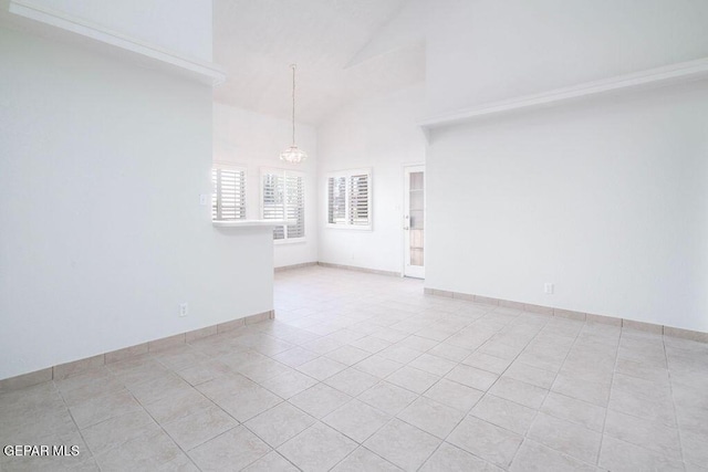 4560 Loma Canada Ct, El Paso, TX 79934 - unfurnished room featuring a chandelier, light tile patterned flooring, high vaulted ceiling, and baseboards
