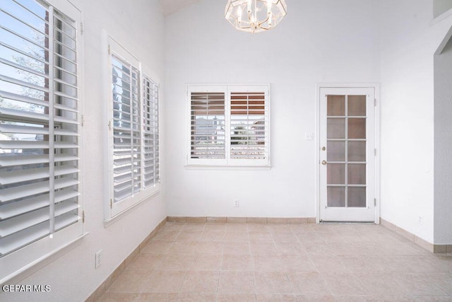 4560 Loma Canada Ct, El Paso, TX 79934 - spare room with healthy amount of natural light, a chandelier, and light tile patterned floors
