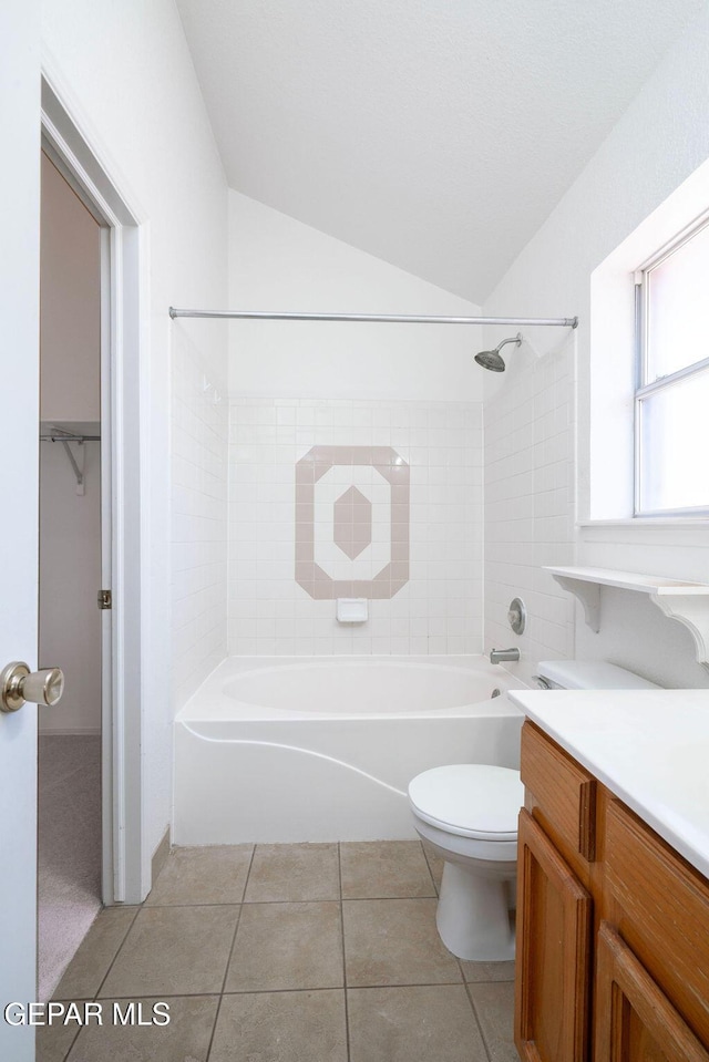 4560 Loma Canada Ct, El Paso, TX 79934 - full bath with washtub / shower combination, vanity, toilet, vaulted ceiling, and tile patterned floors