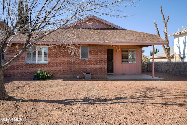 4560 Loma Canada Ct, El Paso, TX 79934 - rear view of property featuring a patio area, a shingled roof, and brick siding
