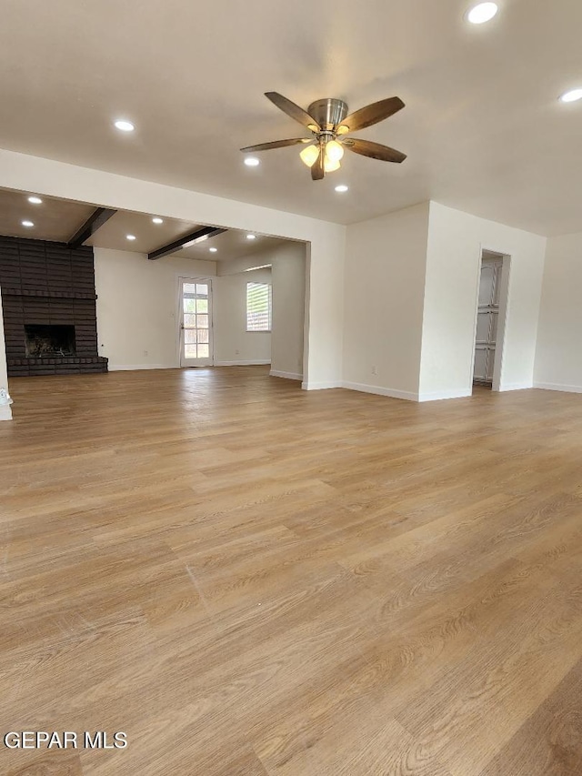 301 Bandolina Dr, Socorro, TX 79927 - unfurnished living room with a ceiling fan, recessed lighting, a fireplace, light wood-style flooring, and baseboards