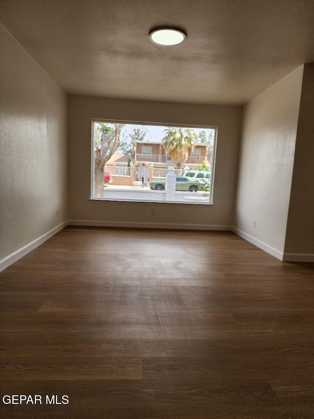 301 Bandolina Dr, Socorro, TX 79927 - unfurnished room featuring dark wood-style floors and baseboards