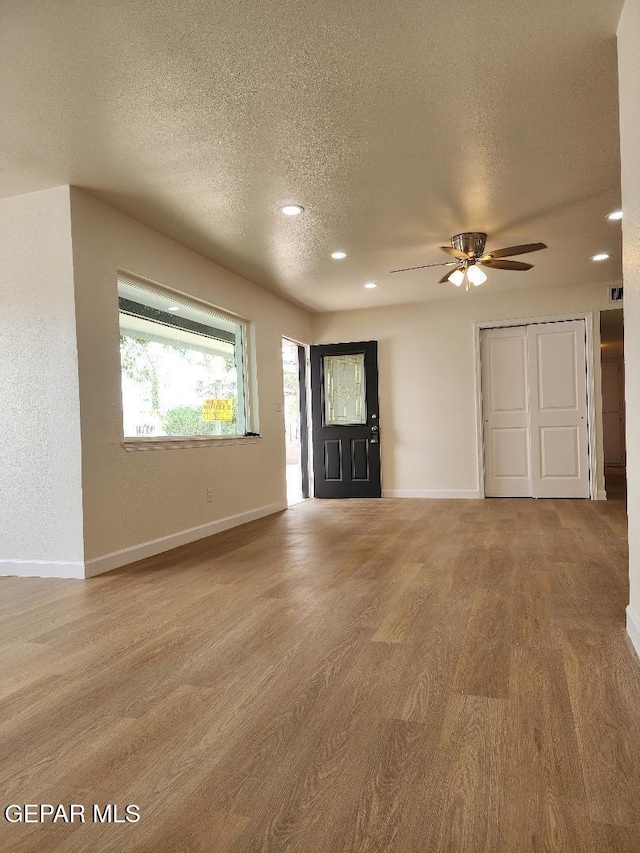301 Bandolina Dr, Socorro, TX 79927 - entryway with wood finished floors, a textured ceiling, baseboards, a ceiling fan, and recessed lighting