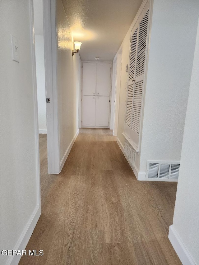 301 Bandolina Dr, Socorro, TX 79927 - hallway featuring wood finished floors and baseboards