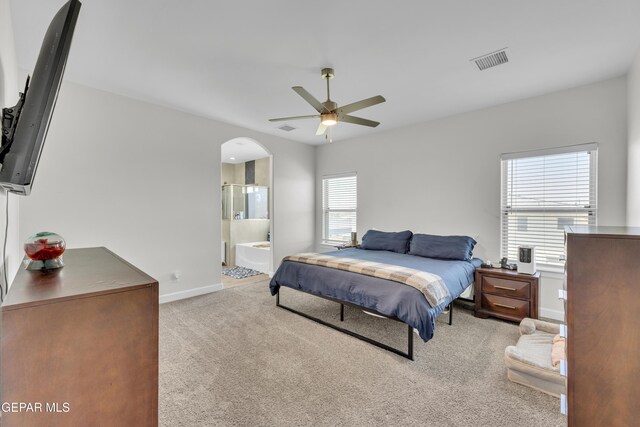 14733 Mike A Mendoza Ave, El Paso, TX 79938 - bedroom featuring carpet floors, arched walkways, baseboards, ensuite bathroom, and a ceiling fan