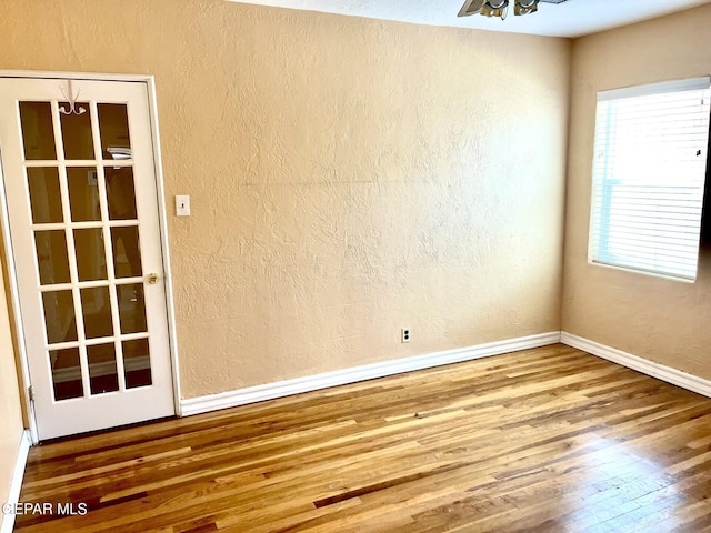3905 Monroe Ave, El Paso, TX 79930 - unfurnished room with wood finished floors, baseboards, a textured wall, and ceiling fan