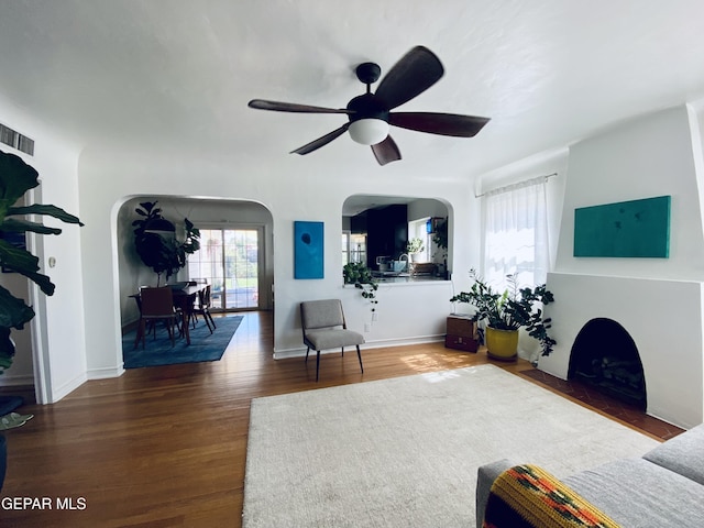 910 Mesita Dr, El Paso, TX 79902 - living area featuring arched walkways, ceiling fan, and wood finished floors