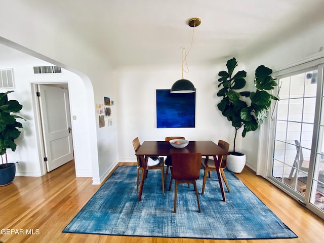 910 Mesita Dr, El Paso, TX 79902 - dining room with arched walkways and light wood finished floors