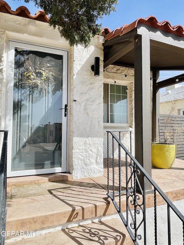 910 Mesita Dr, El Paso, TX 79902 - doorway to property featuring a tile roof