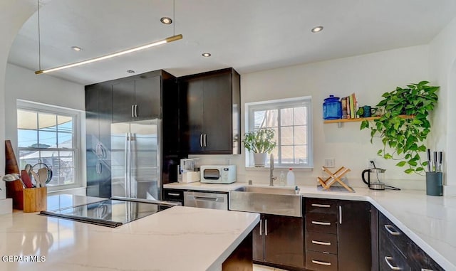 910 Mesita Dr, El Paso, TX 79902 - kitchen with appliances with stainless steel finishes, light stone counters, and recessed lighting