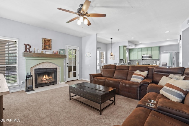 505 Canyon Springs Dr, El Paso, TX 79912 - living room featuring ceiling fan, a fireplace with flush hearth, light colored carpet, baseboards, and recessed lighting