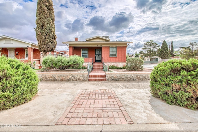 2300 N Campbell St, El Paso, TX 79902 - bungalow-style home with brick siding, covered porch, and a chimney