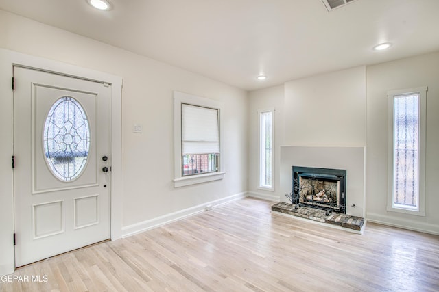 2300 N Campbell St, El Paso, TX 79902 - foyer entrance featuring wood finished floors, a fireplace with raised hearth, and recessed lighting