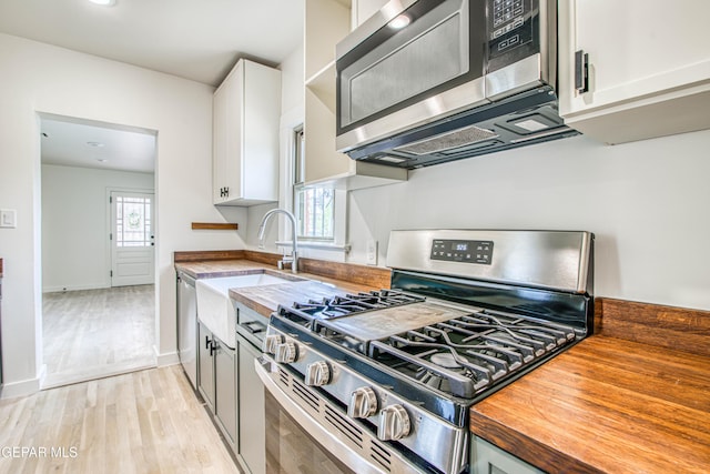 2300 N Campbell St, El Paso, TX 79902 - kitchen with appliances with stainless steel finishes, butcher block counters, light wood-style flooring, and healthy amount of natural light