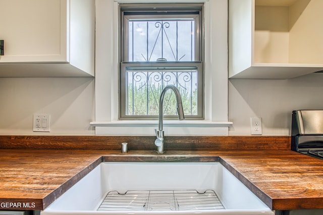 2300 N Campbell St, El Paso, TX 79902 - kitchen view of dark countertops, white cabinetry, and open shelves