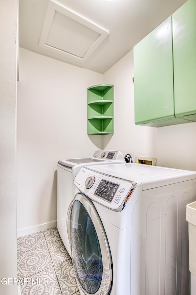 2300 N Campbell St, El Paso, TX 79902 - laundry room featuring washing machine and clothes dryer, attic access, light tile patterned flooring, and cabinet space