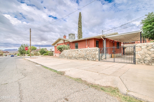 2300 N Campbell St, El Paso, TX 79902 - view of front of home featuring a gate, brick siding, and a chimney