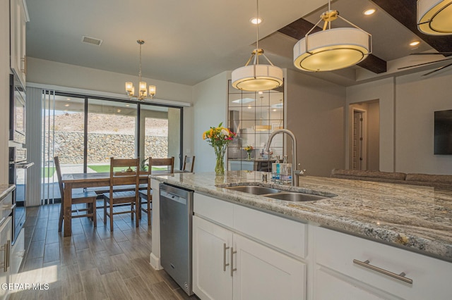 7389 Cimarron Gap Dr, El Paso, TX 79911 - kitchen featuring a sink, stainless steel appliances, light stone counters, white cabinetry, and a chandelier