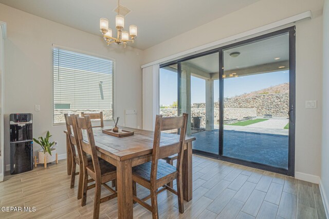 7389 Cimarron Gap Dr, El Paso, TX 79911 - dining space featuring light wood-style floors, a chandelier, plenty of natural light, and baseboards