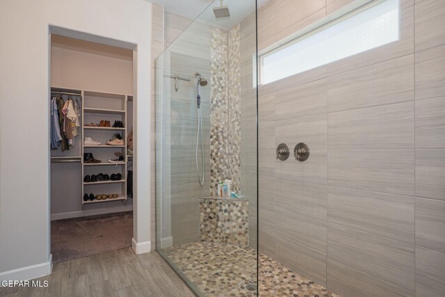 7389 Cimarron Gap Dr, El Paso, TX 79911 - full bath featuring tiled shower, wood finished floors, a spacious closet, and baseboards