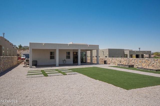 7389 Cimarron Gap Dr, El Paso, TX 79911 - back of house featuring stucco siding and a patio area