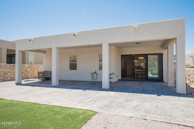 7389 Cimarron Gap Dr, El Paso, TX 79911 - entrance to property with stucco siding and a patio area