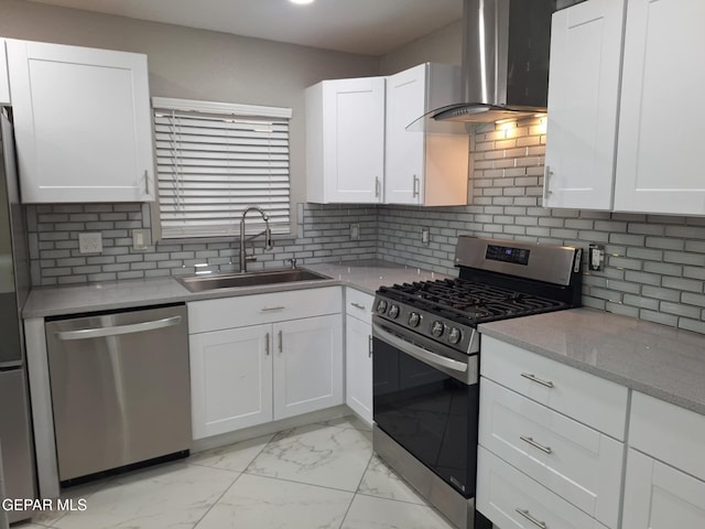11574 La Poblana Dr, Socorro, TX 79927 - kitchen featuring stainless steel appliances, wall chimney range hood, a sink, light marble finish floors, and white cabinetry