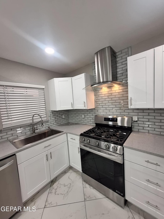 11574 La Poblana Dr, Socorro, TX 79927 - kitchen featuring appliances with stainless steel finishes, wall chimney exhaust hood, a sink, light marble finish floors, and white cabinets