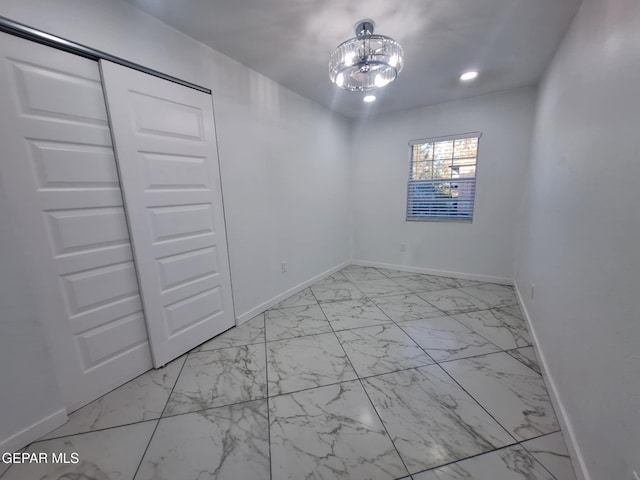 11574 La Poblana Dr, Socorro, TX 79927 - unfurnished bedroom with baseboards, light marble finish flooring, recessed lighting, and a chandelier