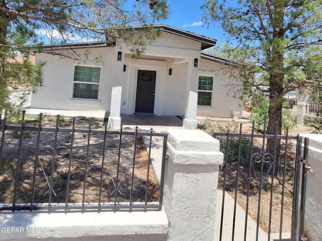 11574 La Poblana Dr, Socorro, TX 79927 - view of front facade with stucco siding, a fenced front yard, and a gate