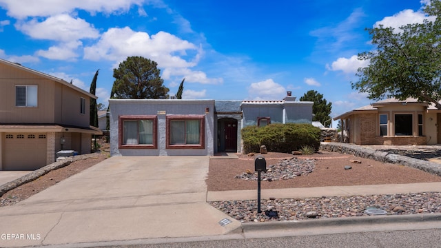 903 Agua Caliente Dr, El Paso, TX 79912 - view of front of property featuring concrete driveway and an attached garage