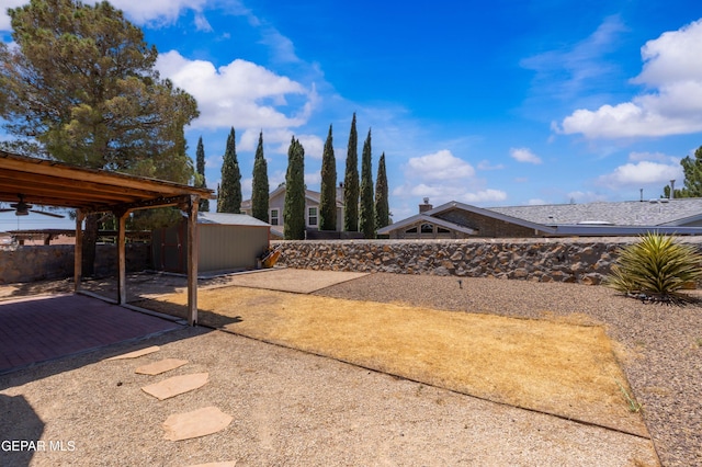 903 Agua Caliente Dr, El Paso, TX 79912 - fenced backyard featuring a patio, an outbuilding, and a storage shed