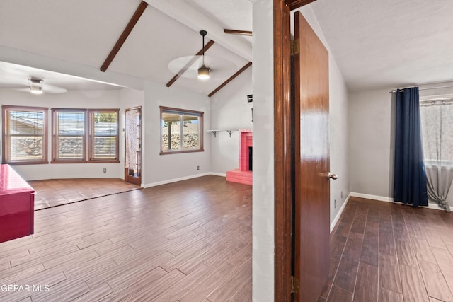 903 Agua Caliente Dr, El Paso, TX 79912 - unfurnished room featuring a ceiling fan, wood finished floors, baseboards, and a brick fireplace