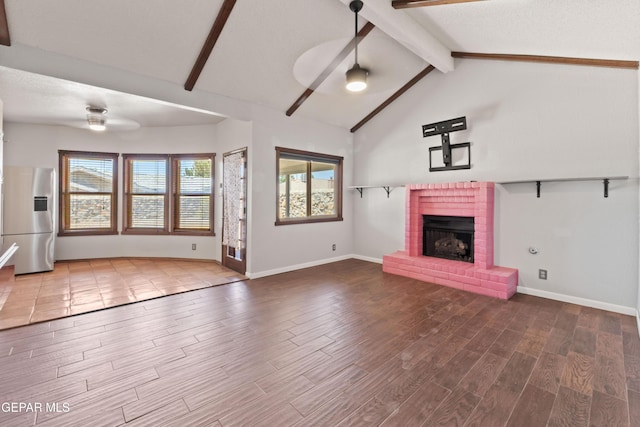 903 Agua Caliente Dr, El Paso, TX 79912 - unfurnished living room with a ceiling fan, a brick fireplace, wood finished floors, and baseboards