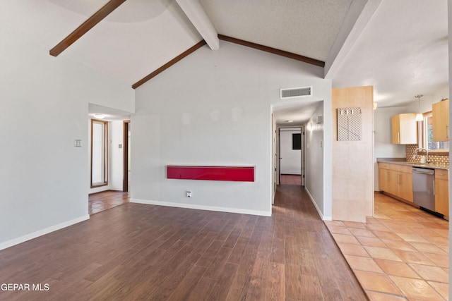 903 Agua Caliente Dr, El Paso, TX 79912 - unfurnished living room featuring beamed ceiling, light wood finished floors, a sink, high vaulted ceiling, and baseboards
