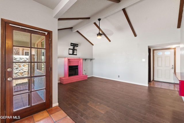 903 Agua Caliente Dr, El Paso, TX 79912 - unfurnished living room with a ceiling fan, a brick fireplace, wood finished floors, and baseboards