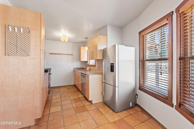 903 Agua Caliente Dr, El Paso, TX 79912 - kitchen featuring stainless steel appliances, a sink, light brown cabinetry, light countertops, and backsplash