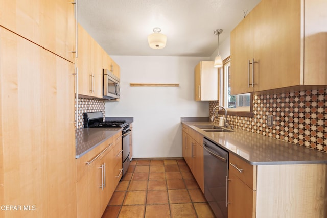 903 Agua Caliente Dr, El Paso, TX 79912 - kitchen with a sink, appliances with stainless steel finishes, light brown cabinetry, decorative backsplash, and decorative light fixtures