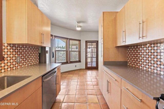 903 Agua Caliente Dr, El Paso, TX 79912 - kitchen featuring dishwasher, light brown cabinetry, backsplash, light countertops, and a textured ceiling