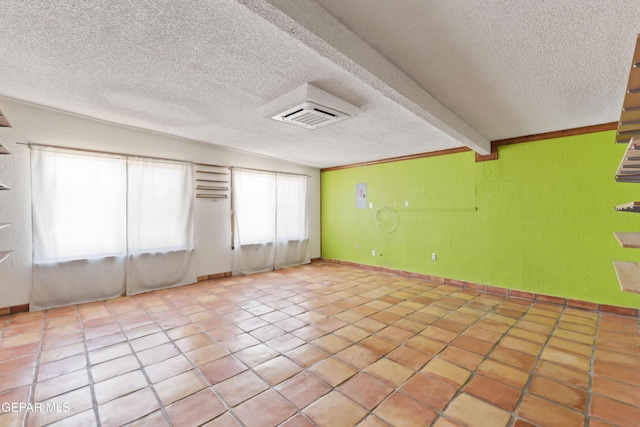 903 Agua Caliente Dr, El Paso, TX 79912 - tiled empty room with a textured ceiling and beam ceiling