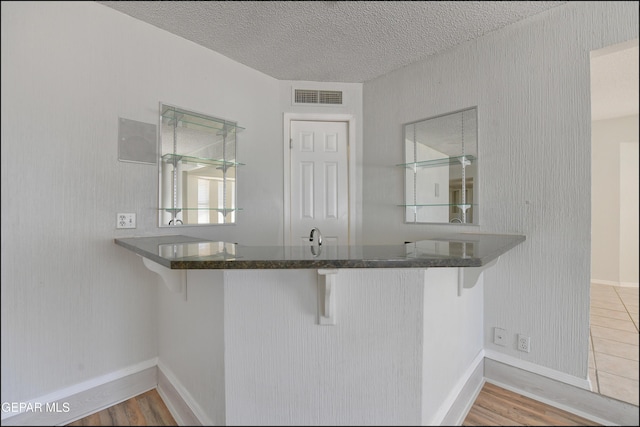 4372 Loma De Oro Dr, El Paso, TX 79934 - bar with a textured ceiling, wood finished floors, and baseboards