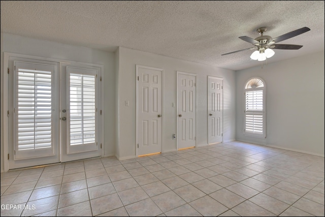 4372 Loma De Oro Dr, El Paso, TX 79934 - spare room featuring light tile patterned floors, ceiling fan, a textured ceiling, french doors, and baseboards