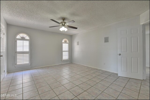 4372 Loma De Oro Dr, El Paso, TX 79934 - spare room with ceiling fan, a textured ceiling, light tile patterned flooring, and baseboards